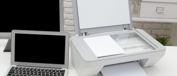 scanner alongside laptop on a desk